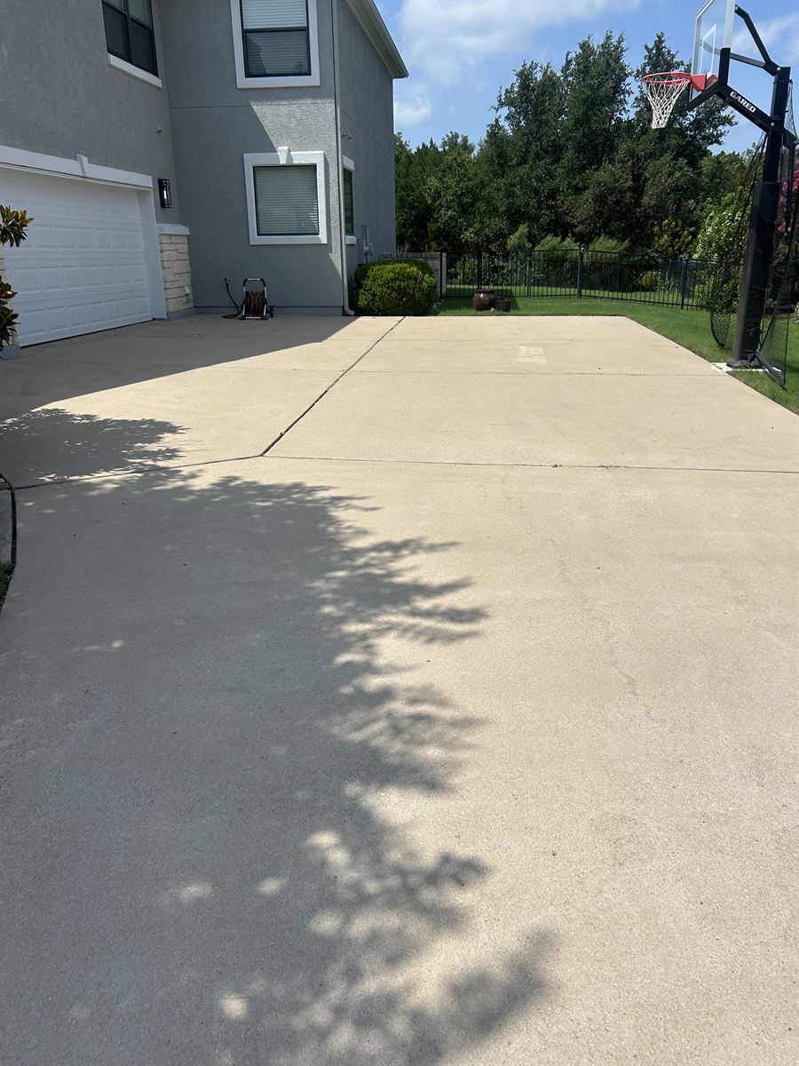 The same backyard sport court cleaned to an even, bright finish